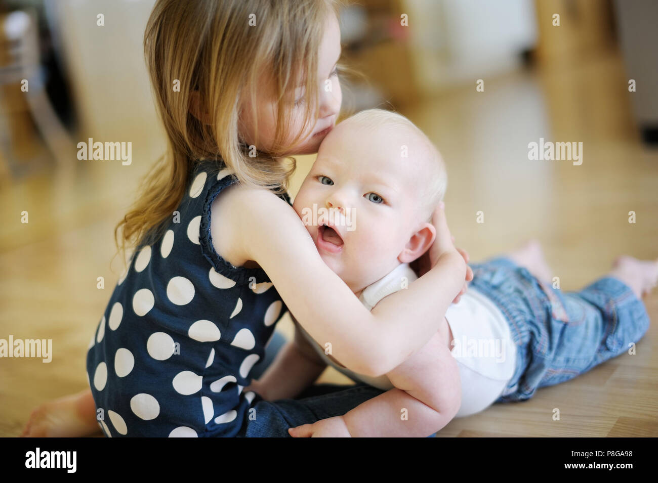 Two little sisters embracing each other Stock Photo - Alamy