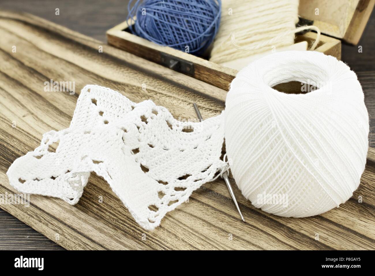 Still life with crochet doily and white yarn Stock Photo