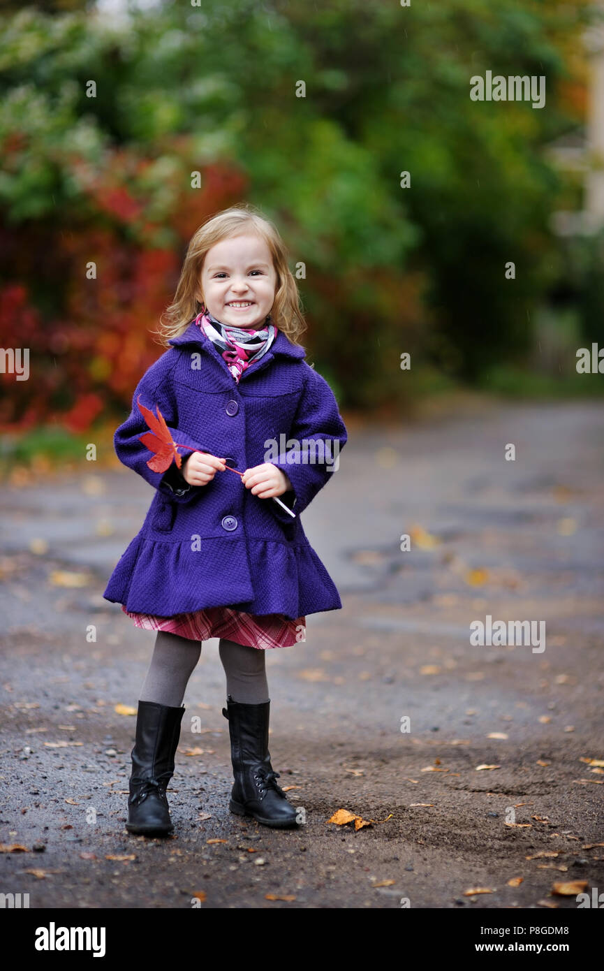 Cute little girl in a blue coat at autumn Stock Photo Alamy