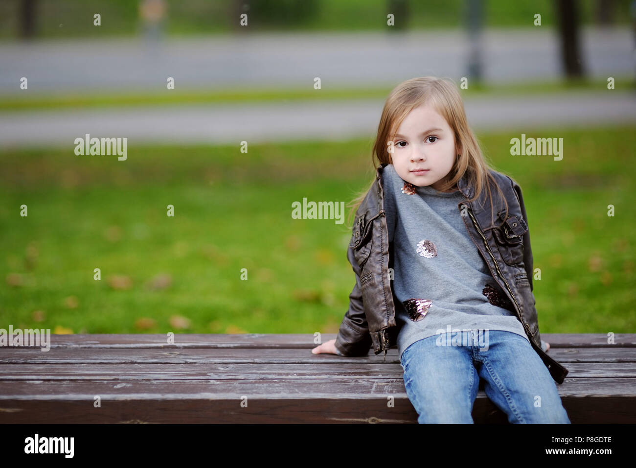 Adorable little girl portrait outdoors at autumn Stock Photo - Alamy