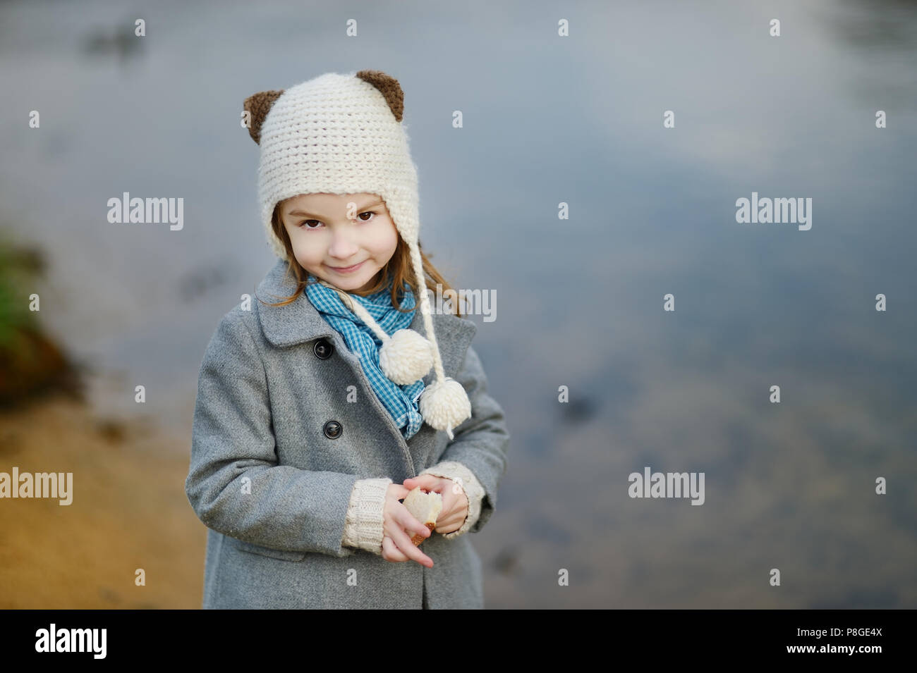 Adorable little girl by a river on autumn day Stock Photo - Alamy