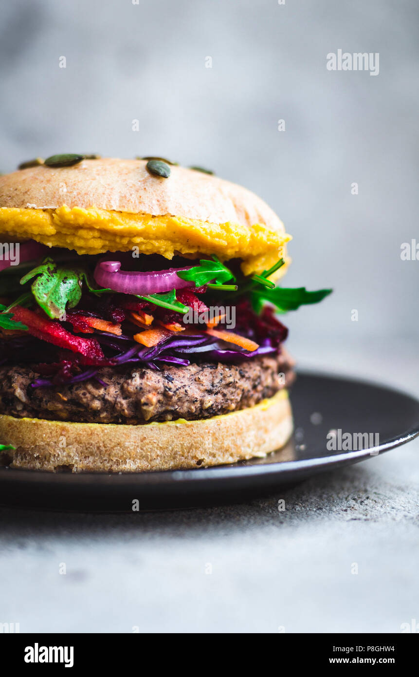 Black bean burgers with colourful toppings and hummus Stock Photo Alamy
