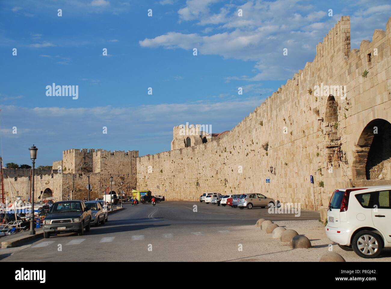 The medieval fortified wall by Kolona port in Rhodes Old Town on the Greek island of Rhodes on June 12, 2018. Stock Photo