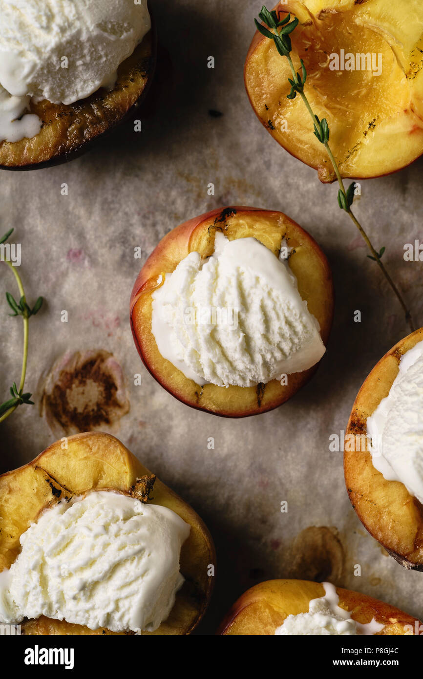 Grilled peaches and nectarines served with vanilla ice cream Stock