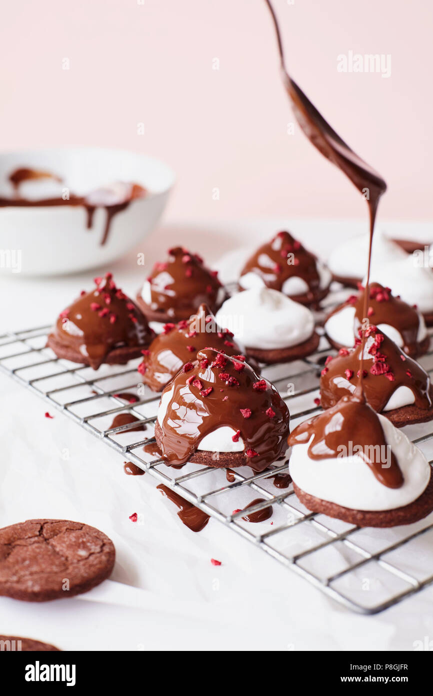 Drizzling Melted Chocolate on Marshmallow Teacakes Stock Photo Alamy