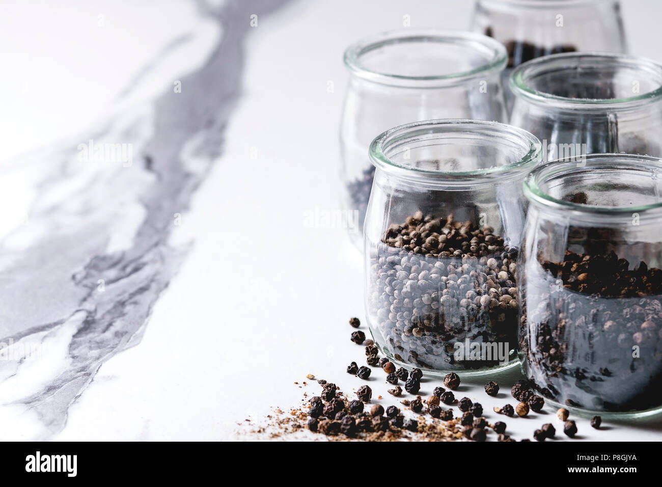 Variety of different black peppers allspice, pimento, long pepper