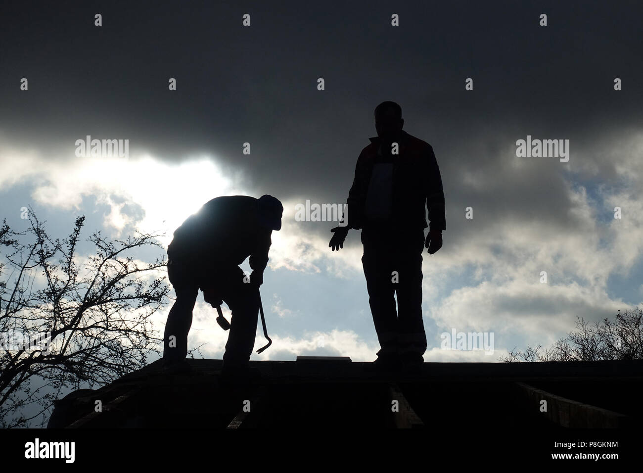 Berlin, Germany, Silhouette, craftsman working on the roof of a gazebo Stock Photo