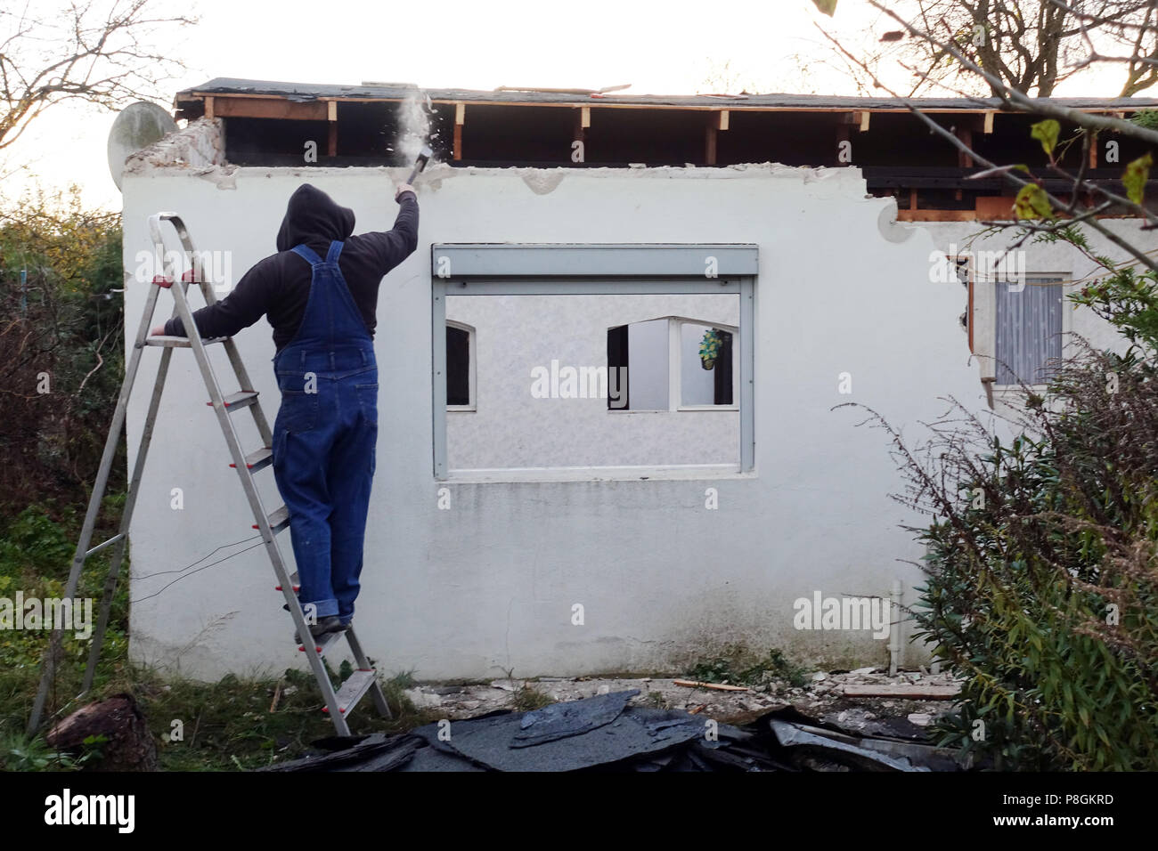 Berlin, Germany, artisan beating a wall in the rebuilding of a gazebo Stock Photo