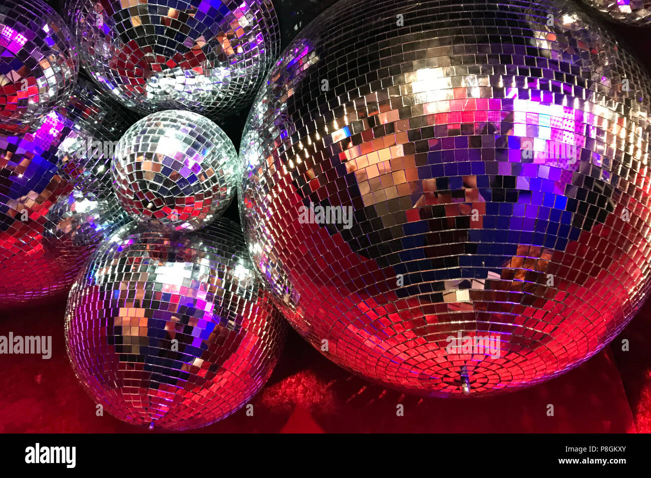 disco balls for decorationof a party on pink background Stock Photo - Alamy