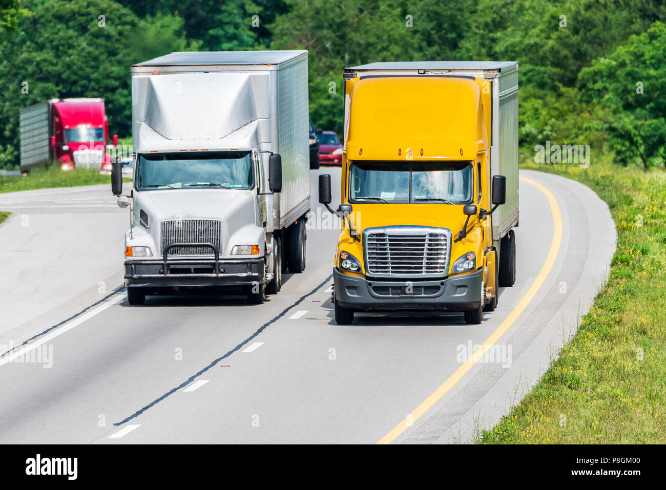 Heavy trucks and other vehicles travel a highway in Tennessee. Note: All logos and identifying marks have been removed from all vehicles.  Image was c Stock Photo