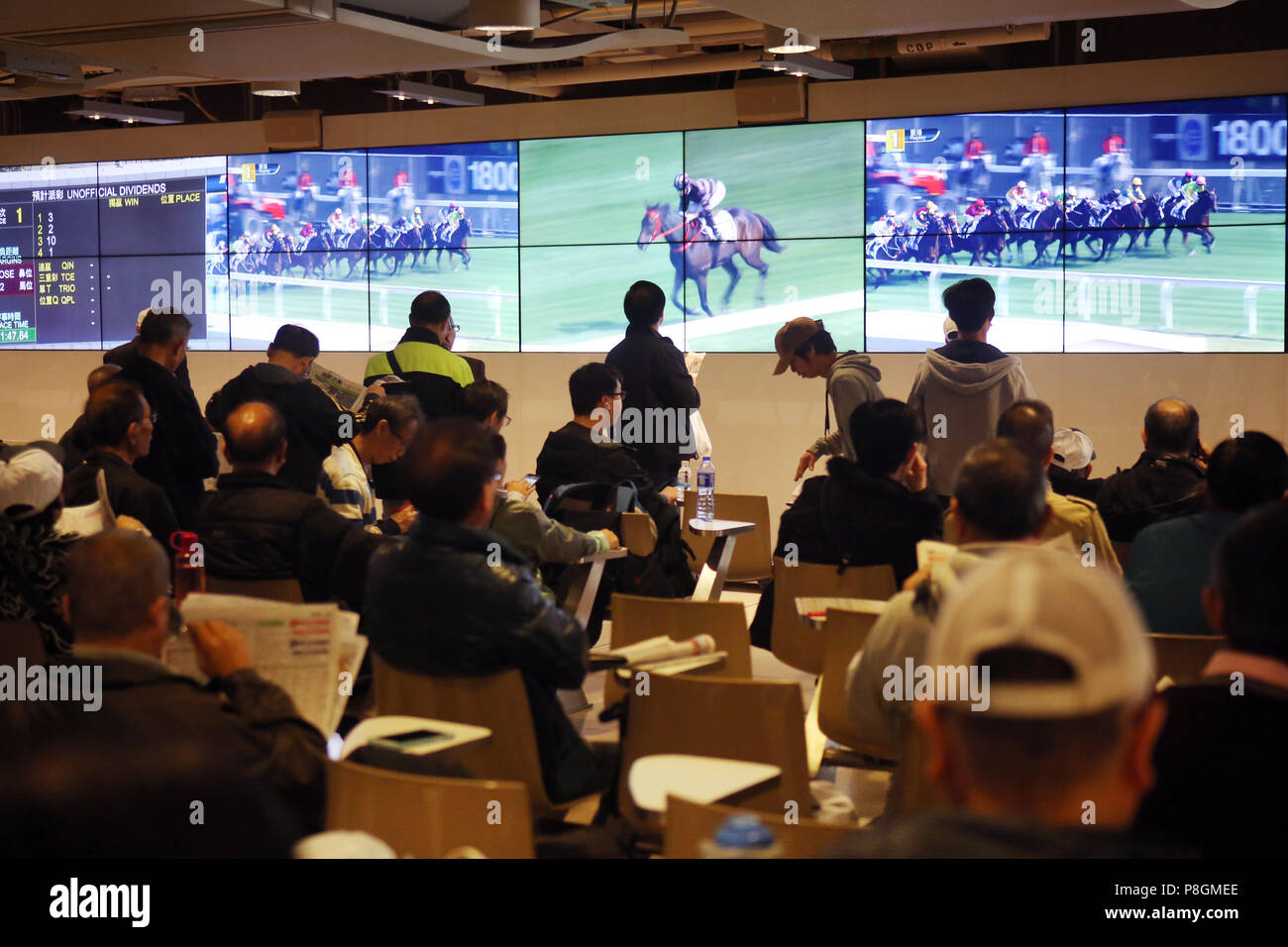 Hong Kong, China, people in a betting hall of the racecourse Sha Tin Stock Photo