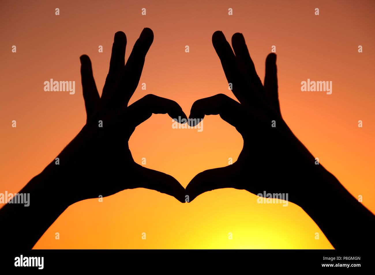 Silhouette heart shaped hands hi-res stock photography and images - Alamy
