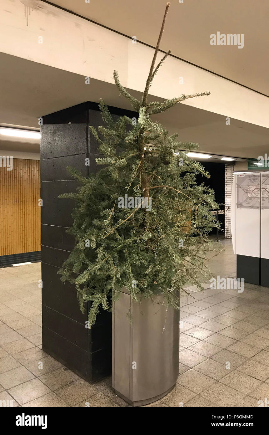 Berlin, Germany, Christmas tree is in a trash can on a subway station Stock Photo