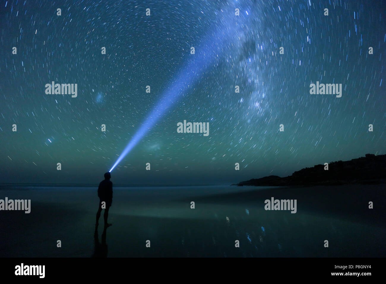 Man gazing at the bright night sky with thousands of beautiful stars. Stock Photo