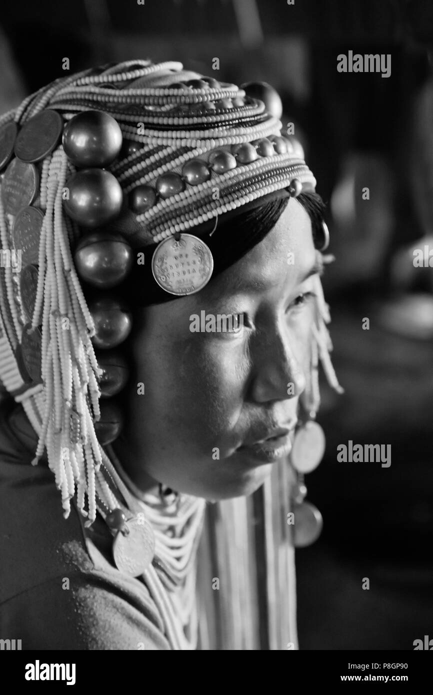 Women of the AKHA tribe wear elaborate headdresses made of beads, silver coins and hand loomed cotton -  village near KENGTUNG or KYAINGTONG,  MYANMAR Stock Photo