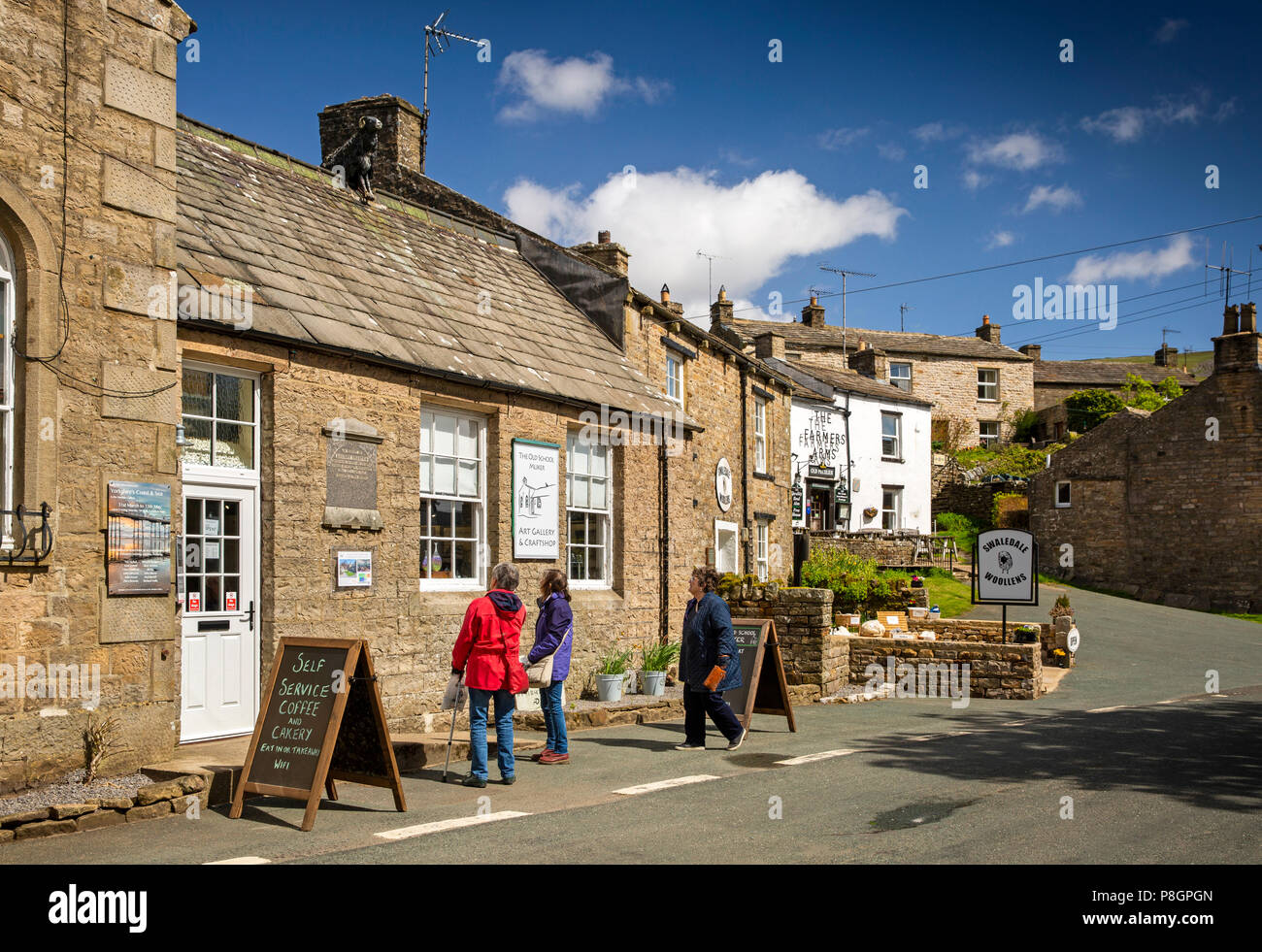 UK, England, Yorkshire, Swaledale, Muker, visitors outside Old School art gallery in village centre Stock Photo