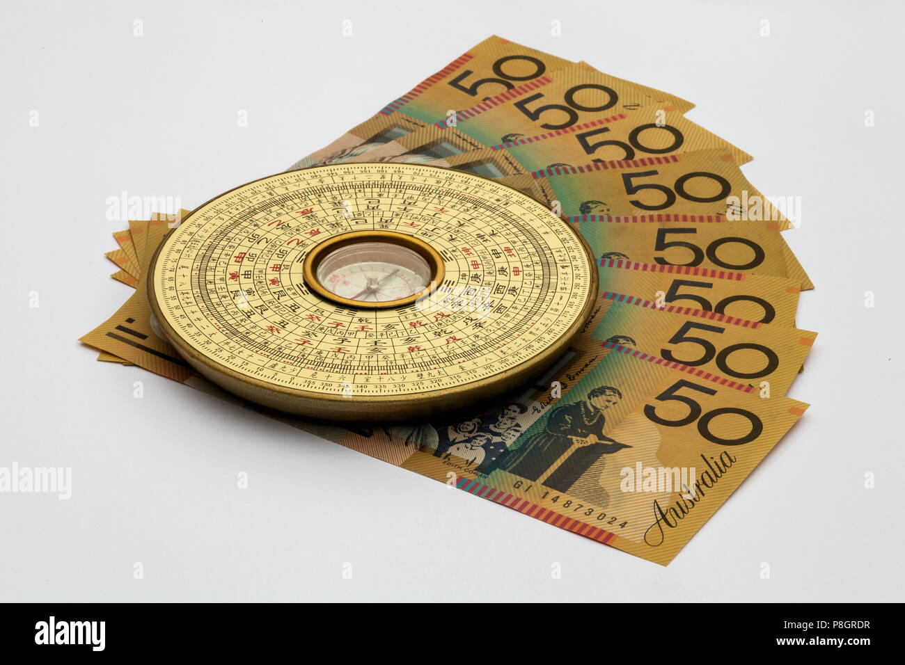 Chinese Feng Shui compass on top of Australian Money Stock Photo
