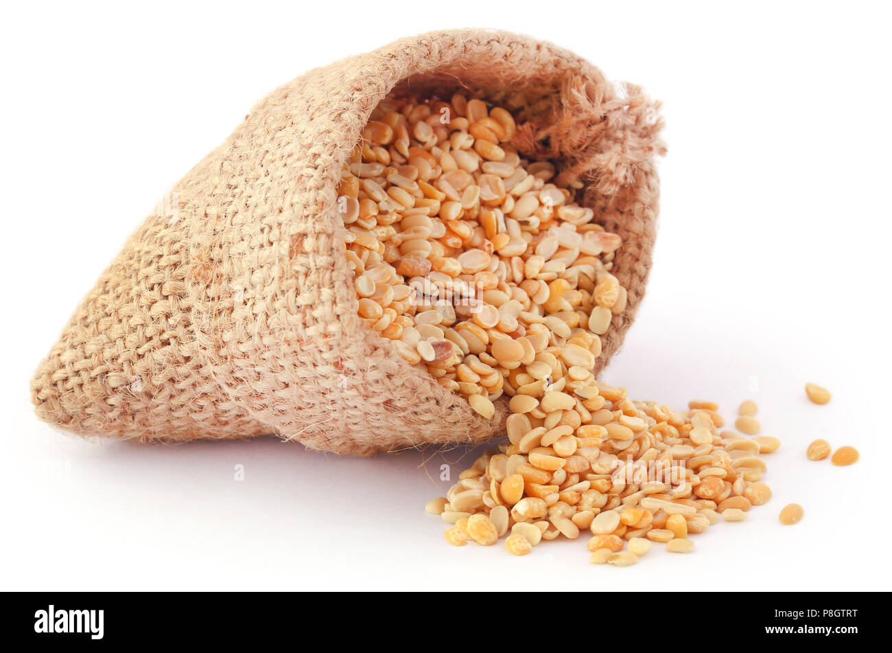 Peeled mung bean in jute sack over white background Stock Photo