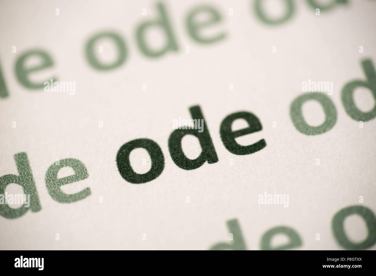 word ode  printed on white paper macro Stock Photo