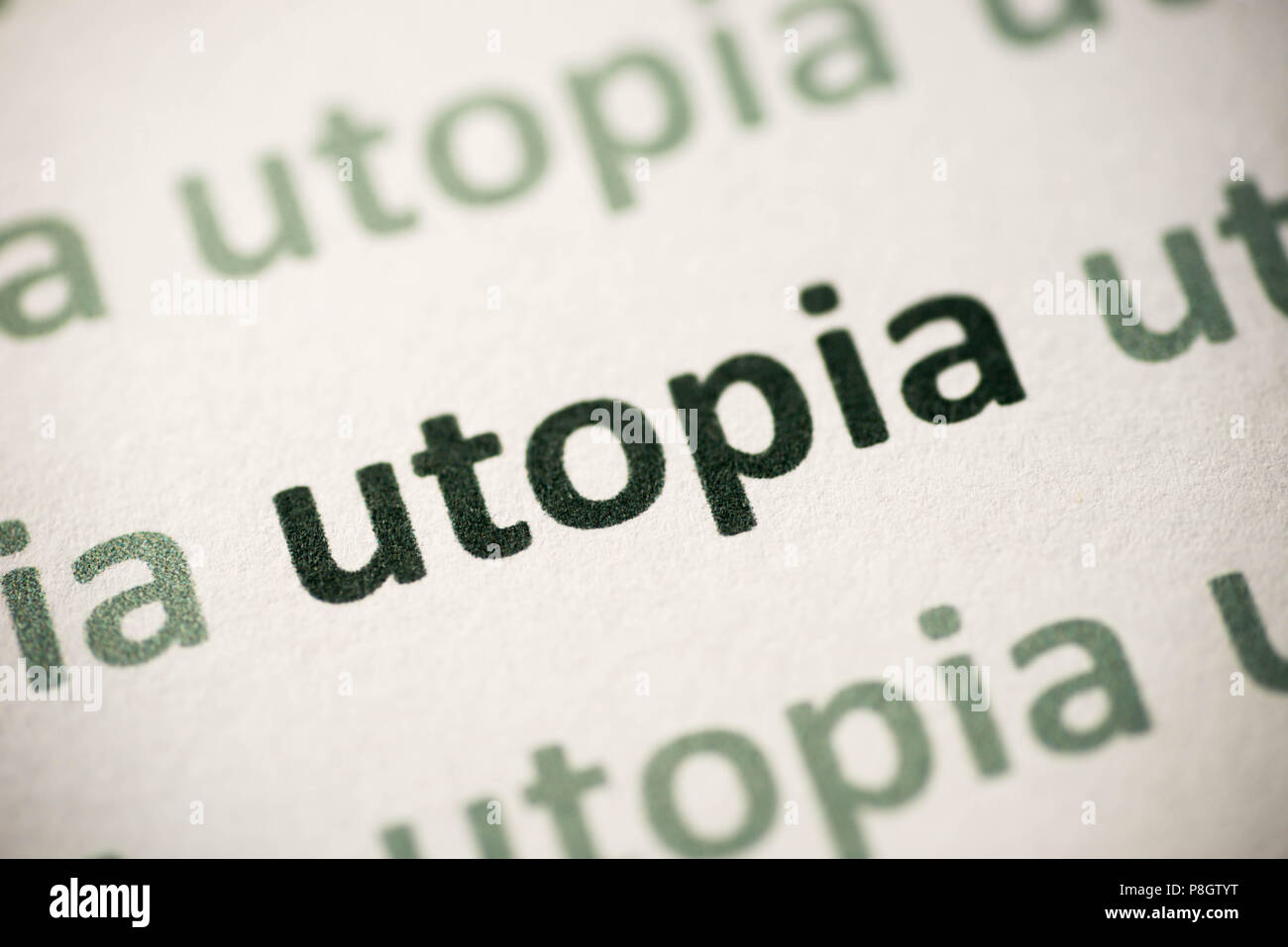 word utopia printed on white paper macro Stock Photo