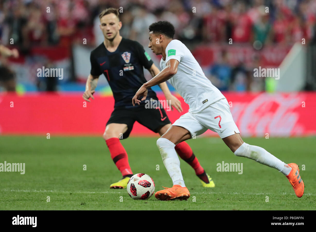 MOSCOW, RUSSIA - JULY 11: Jesse Lingard (R) of England and Ivan Rakitic of Croatia vie for the ball during the 2018 FIFA World Cup Russia Semi Final match between England and Croatia at Luzhniki Stadium on July 11, 2018 in Moscow, Russia. MB Media Stock Photo