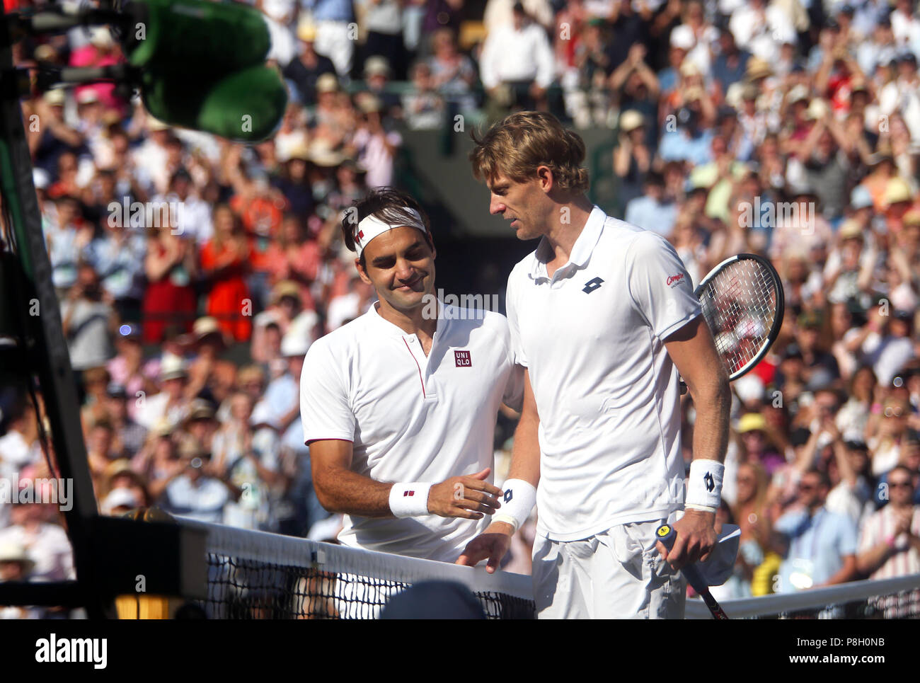 London, UK. 11th July, 2018. Wimbledon Tennis:Roger Federer is consoled by  opponent Kevin Anderson of South Africa after Anderson's five set victory  over Federe in the quarter finals at Wimbledon today. Credit: