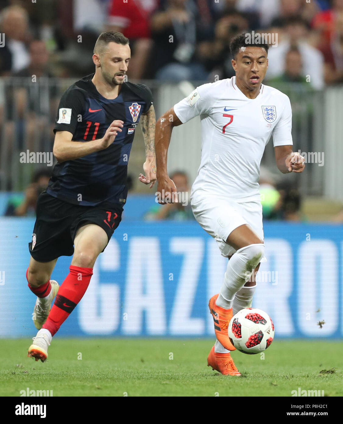 Moscow, Russia. 11th July, 2018. Jesse Lingard (R) of England vies with Marcelo Brozovic of Croatia during the 2018 FIFA World Cup semi-final match between England and Croatia in Moscow, Russia, July 11, 2018. Credit: Cao Can/Xinhua/Alamy Live News Stock Photo