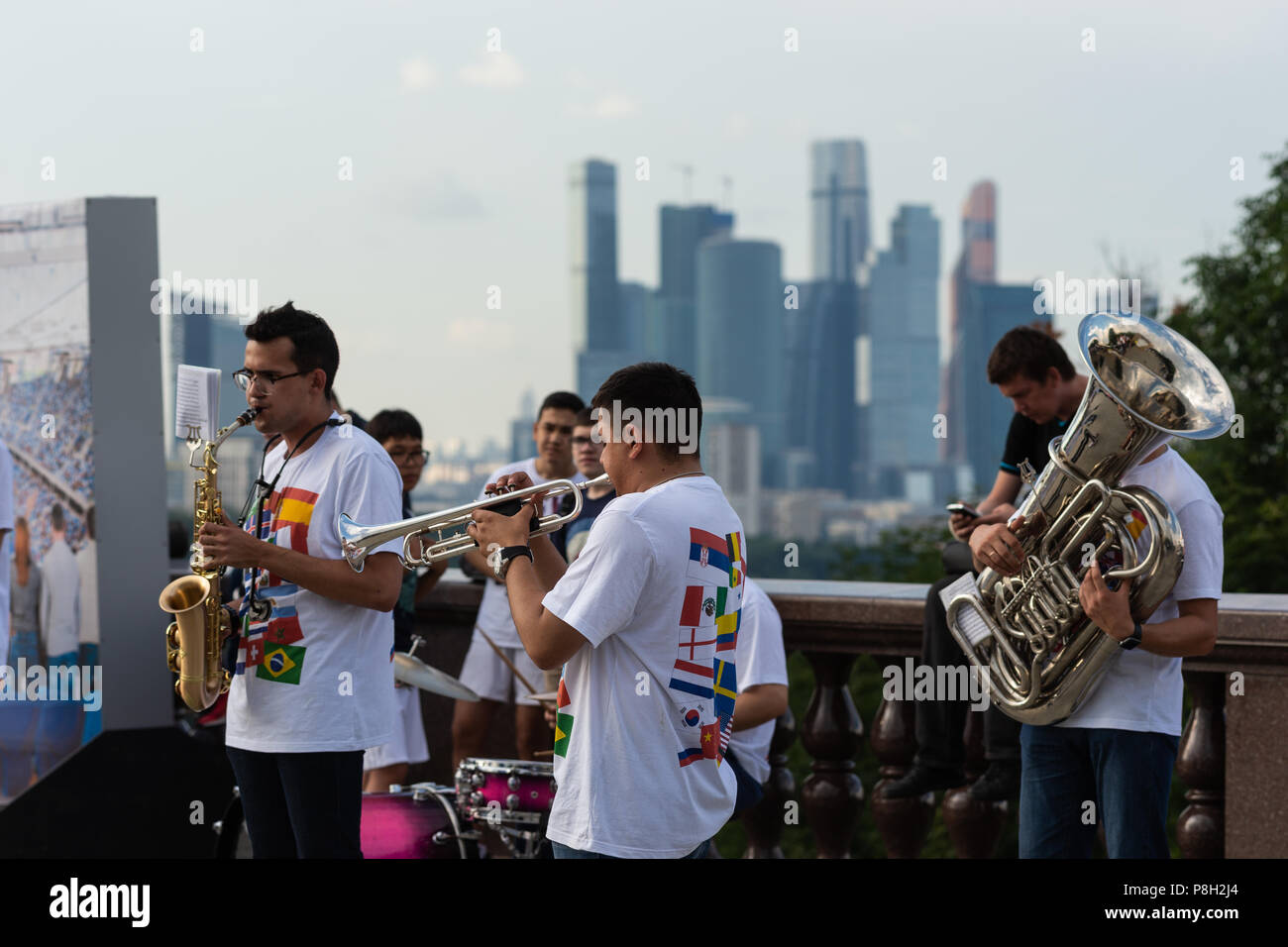Moscow, Russia. 11th July, 2018. Fan Festival area on Sparrow Hills. Football fans gather to view England vs Croatia semi-final on large TV screens. Concert and activity before the match. In spite of local thunderstorms over Moscow, the festival atmosphere is warm. Orchestra greets the international football fans on the viewing platform. Credit: Alex's Pictures/Alamy Live News Stock Photo