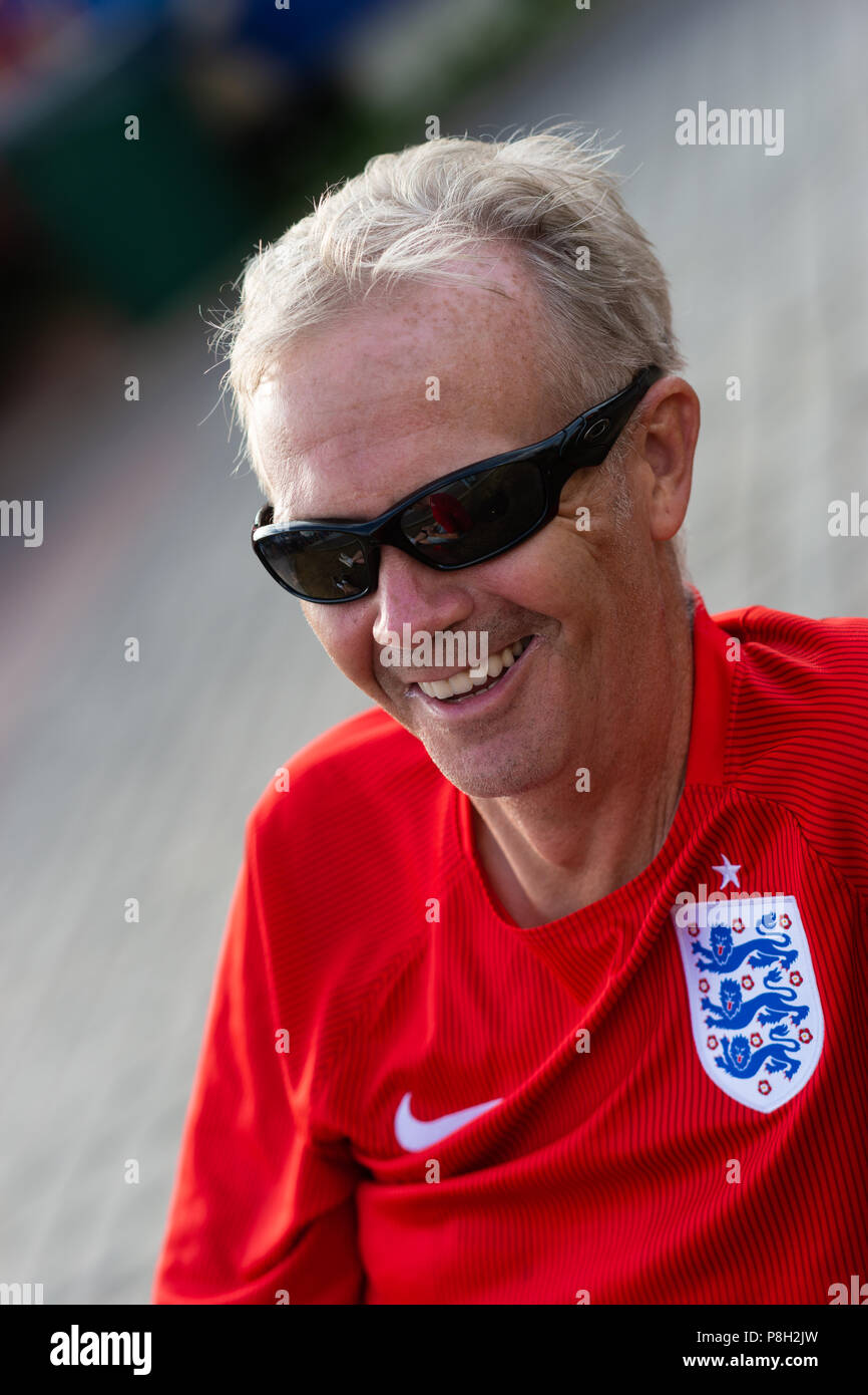 Moscow, Russia. 11th July, 2018. Fan Festival area on Sparrow Hills. Football fans gather to view England vs Croatia semi-final on large TV screens. Concert and activity before the match. In spite of local thunderstorms over Moscow, the festival atmosphere is warm. Unidentified supporter of England football team. Credit: Alex's Pictures/Alamy Live News Stock Photo