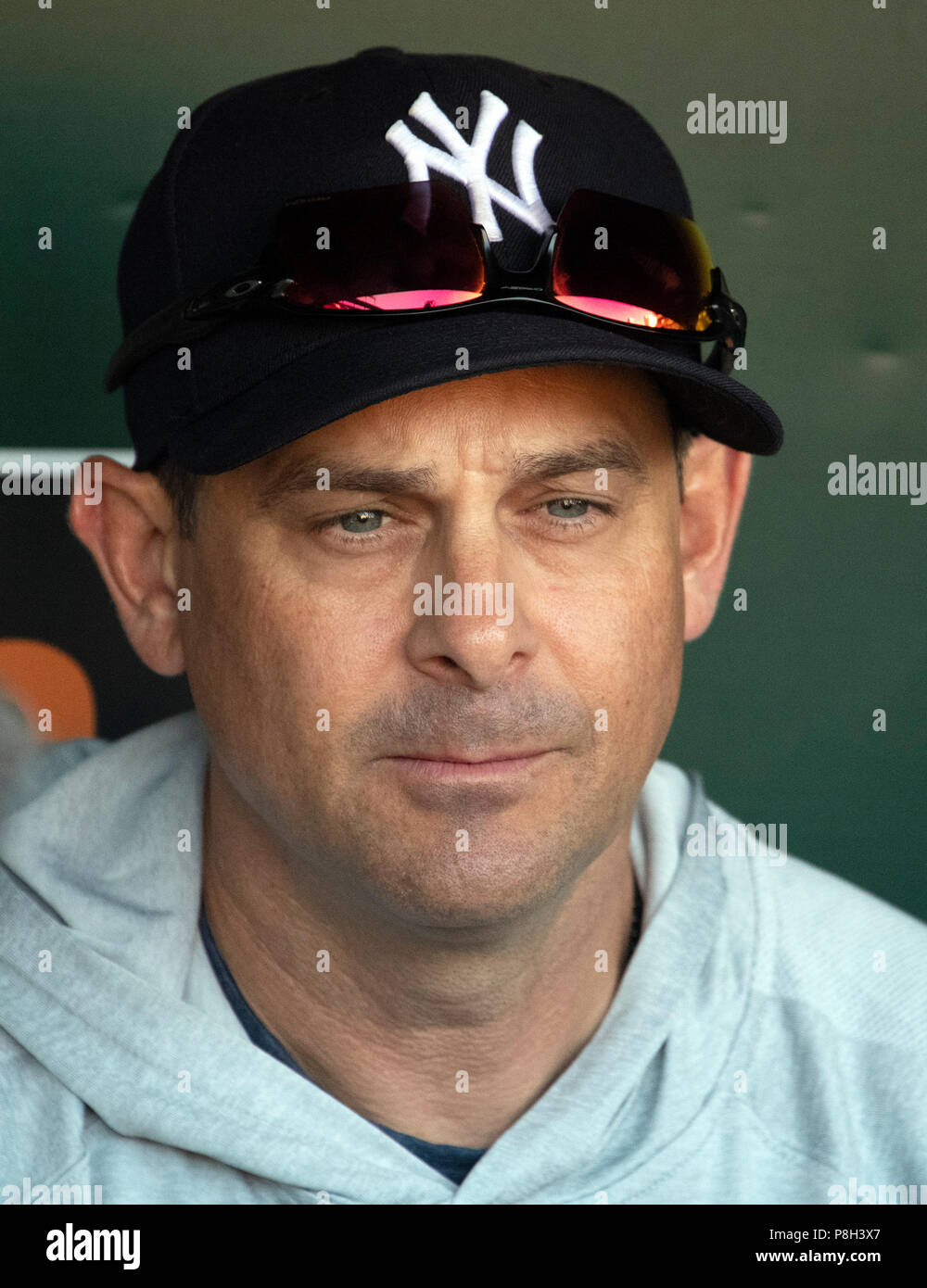 Baltimore, United States Of America. 11th July, 2018. New York Yankees  manager Aaron Boone (17) seems to be flexing his muscles in the dugout  prior to the game against the Baltimore Orioles