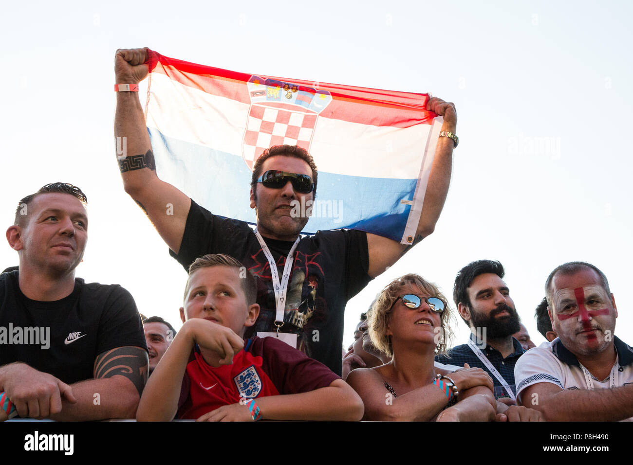 London, UK. 11th July, 2018. A Croatia supporter waves a Croatian flag after Croatia score among 30,000 England fans attending the public screening of the FIFA 2018 World Cup semi-final between England and Croatia in Hyde Park, the largest such screening of a football match since 1996. The event was organised by the Mayor of London and Government in conjunction with the Royal Parks, the Football Association and other agencies. The match provides England with the chance to reach their first World Cup final since 1966. Credit: Mark Kerrison/Alamy Live News Stock Photo