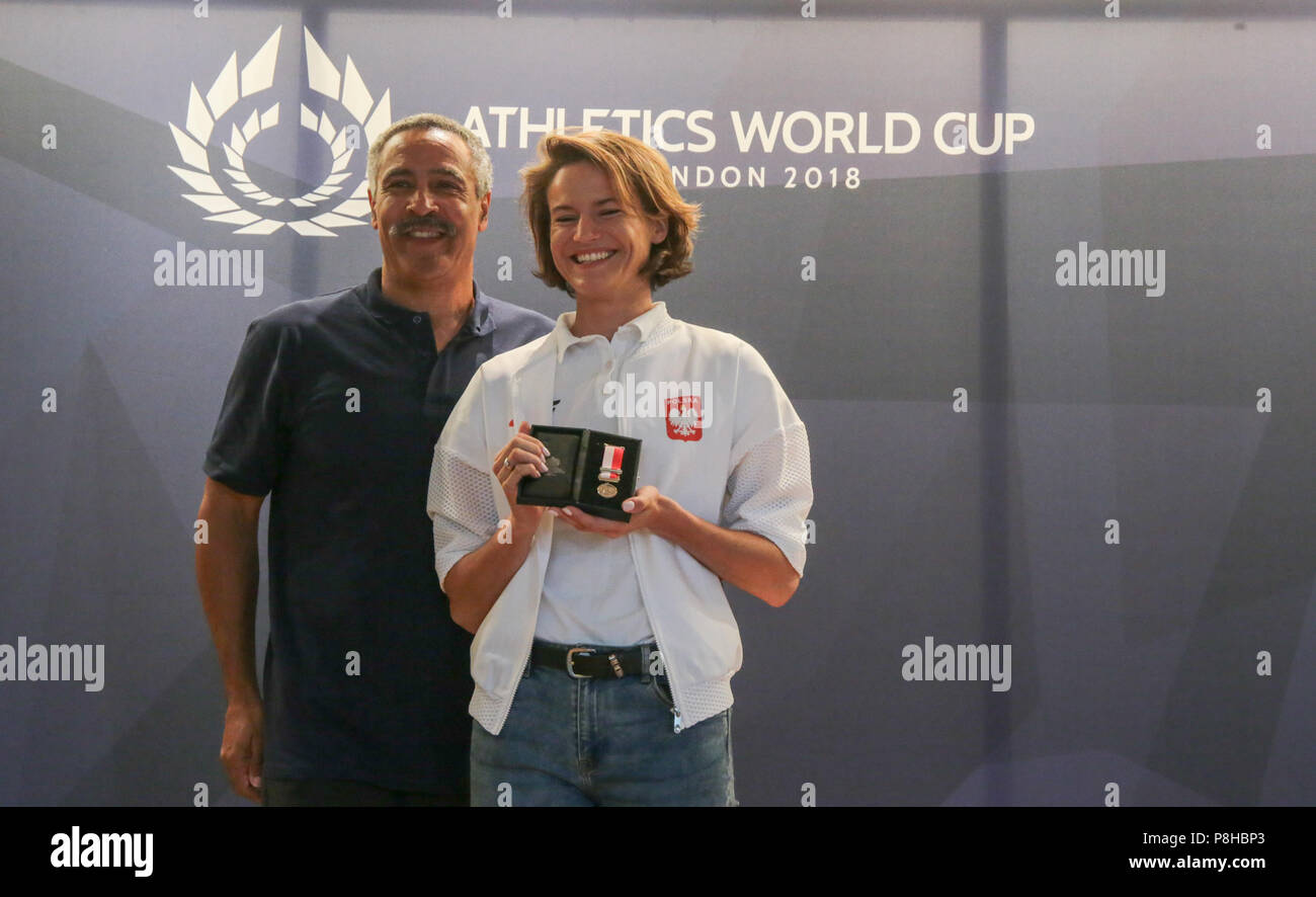 London UK 12 July 2018 Sally Gunnell,1992 Olympic 400m hurdles champion and world, European and Commonwealth champion; former world record holder, and  Daley Thompson  two times Olympic decathlon champion and world, European and Commonwealth champion; former world record holder, were  in the London Museum , presenting platinum medals to team captains who will be competing at the Athletics World  cup this week end to mark 100 years since first British Women secure the right to voteDley Thompson presenting Anna Jagaciak-Michalska of Poland with her medal Credit: Paul Quezada-Neiman/Alamy Live Ne Stock Photo