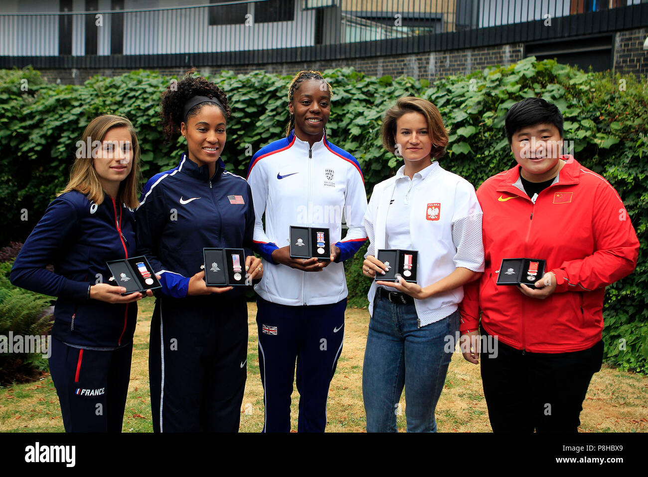 London, UK. 11th July, 2018. Lorraine Ugen of Great Britain ©, Queen Harrison of the USA (2L), Ninon Guillon-Romarin of France (1L), Anna Jagaciak-Michalska of Poland (1R) and Gong Lijiao of China (2R) pose with their medals.  all the athletics world cup team captains, all Women, today are presented with unique Platinum captain's medals marking 100 years since first British women secured the right to vote. Athletics World Cup media day at the Terrace Gallery, Museum of London in London on Thursday 12th July 2018. Credit: Andrew Orchard sports photography/Alamy Live News Stock Photo