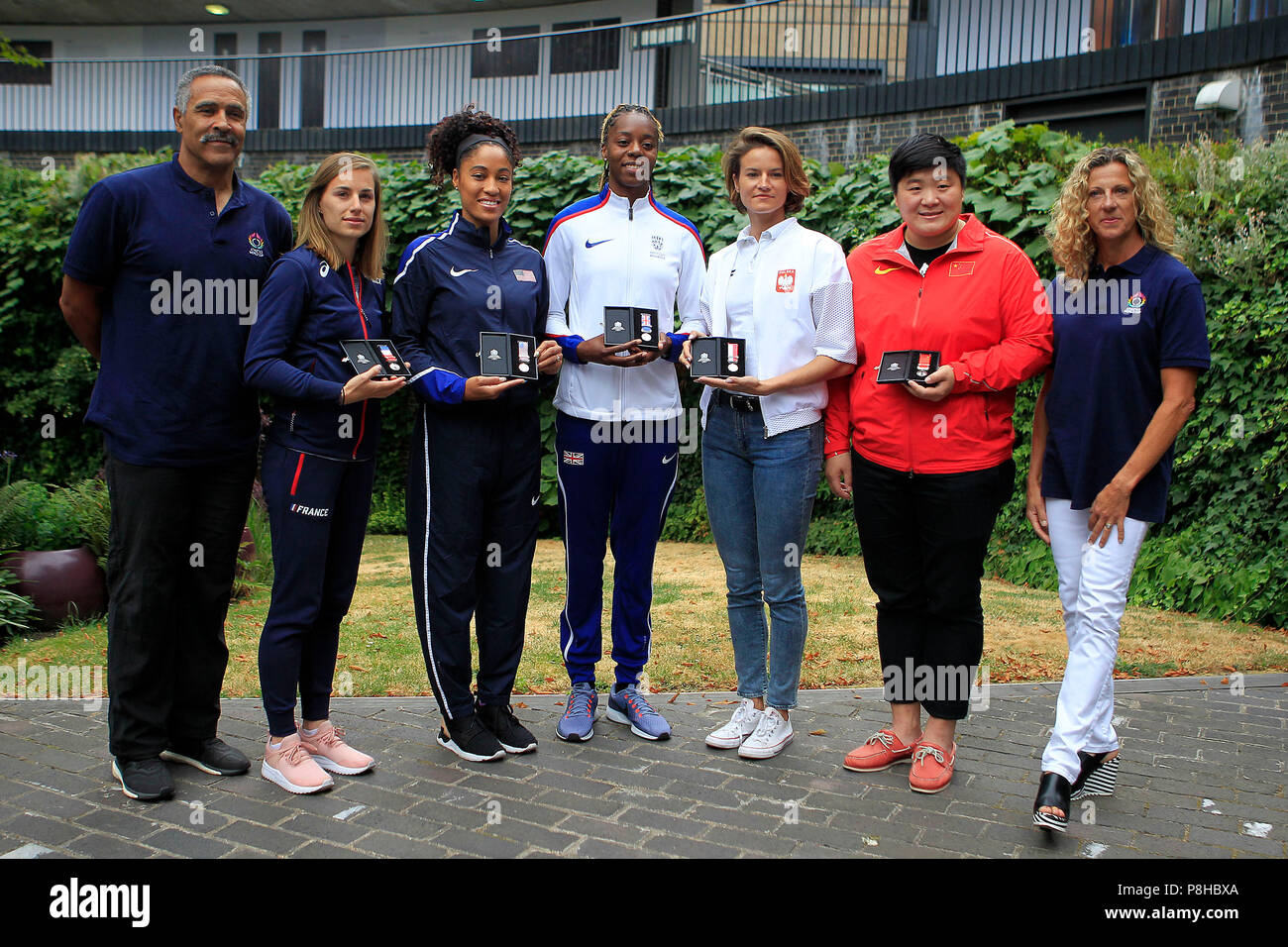 London, UK. 11th July, 2018. Lorraine Ugen of Great Britain ©, Queen Harrison of the USA (2L), Ninon Guillon-Romarin of France (1L), Anna Jagaciak-Michalska of Poland (1R) and Gong Lijiao of China (2R) pose with their medals with Daley Thompson (1L) and Sally Gunnell (3R).  all the athletics world cup team captains, all Women, today are presented with unique Platinum captain's medals marking 100 years since first British women secured the right to vote. Credit: Andrew Orchard sports photography/Alamy Live News Stock Photo