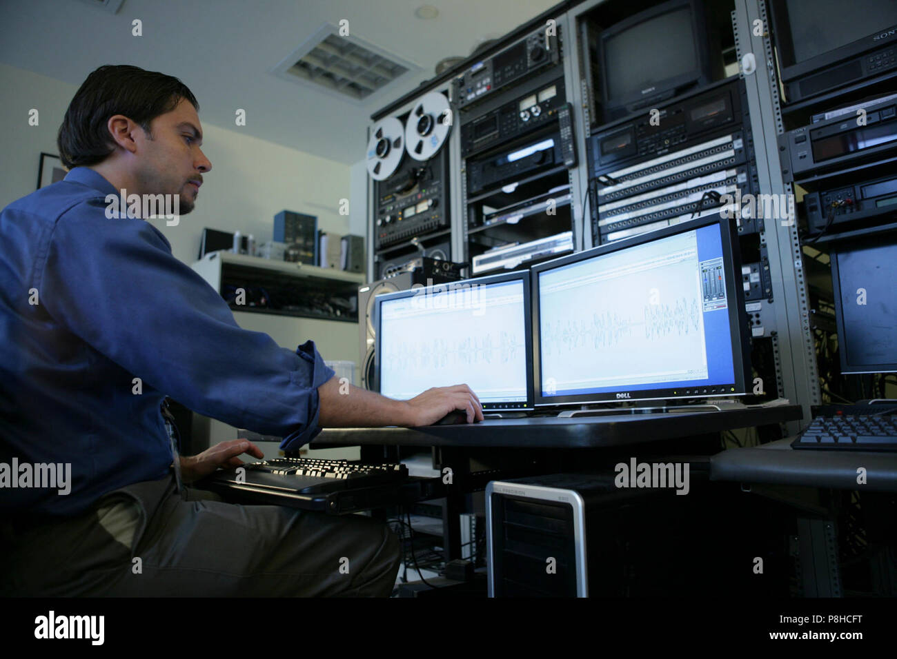 80th Anniversary Celebration  . Bill Bjelf, Assistant Digital Archivist for AV Collections (JFK Library Foundation) works on audiovisual material at 80the library's digital audio workstation.; Location: John F. Kennedy Presidential Library, Boston, MA; Stock Photo