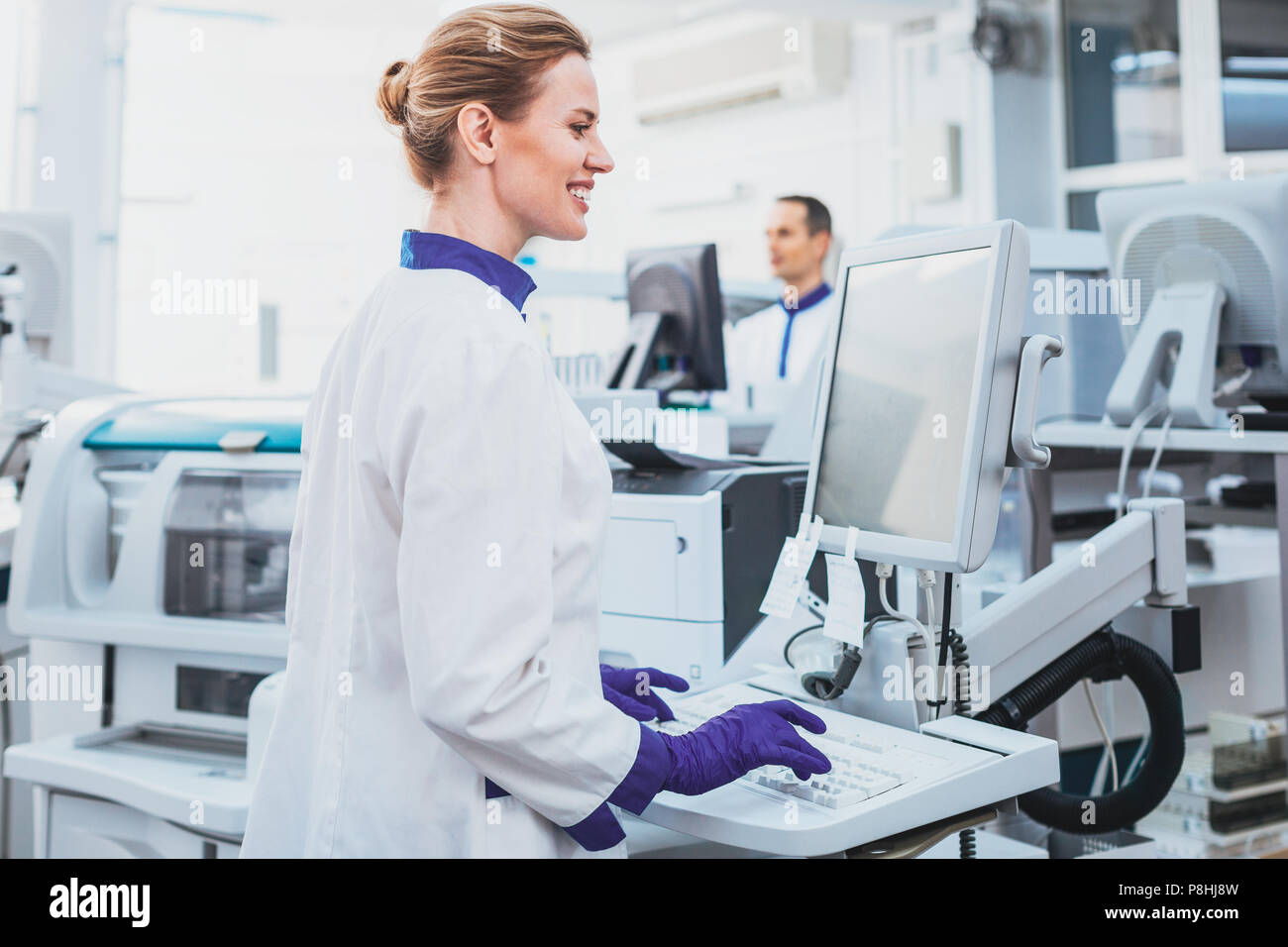 Happy medical worker doing experiment Stock Photo