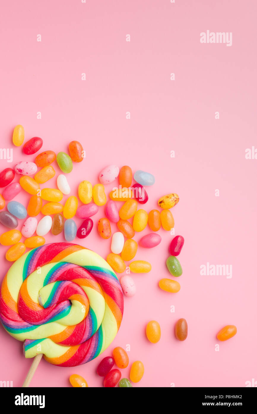 Sweet jelly beans and lollipop on colorful background Stock Photo Alamy