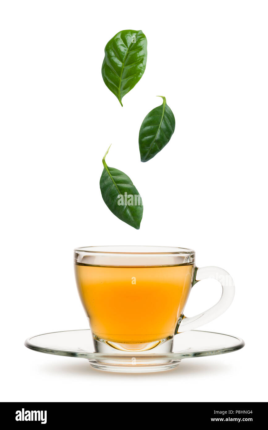tea leaves falling into tea cup, on white background Stock Photo - Alamy