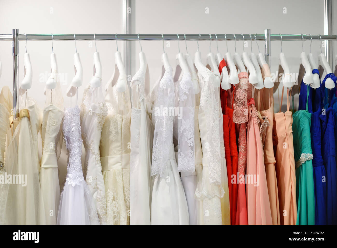 A few beautiful wedding dresses on a hanger Stock Photo - Alamy