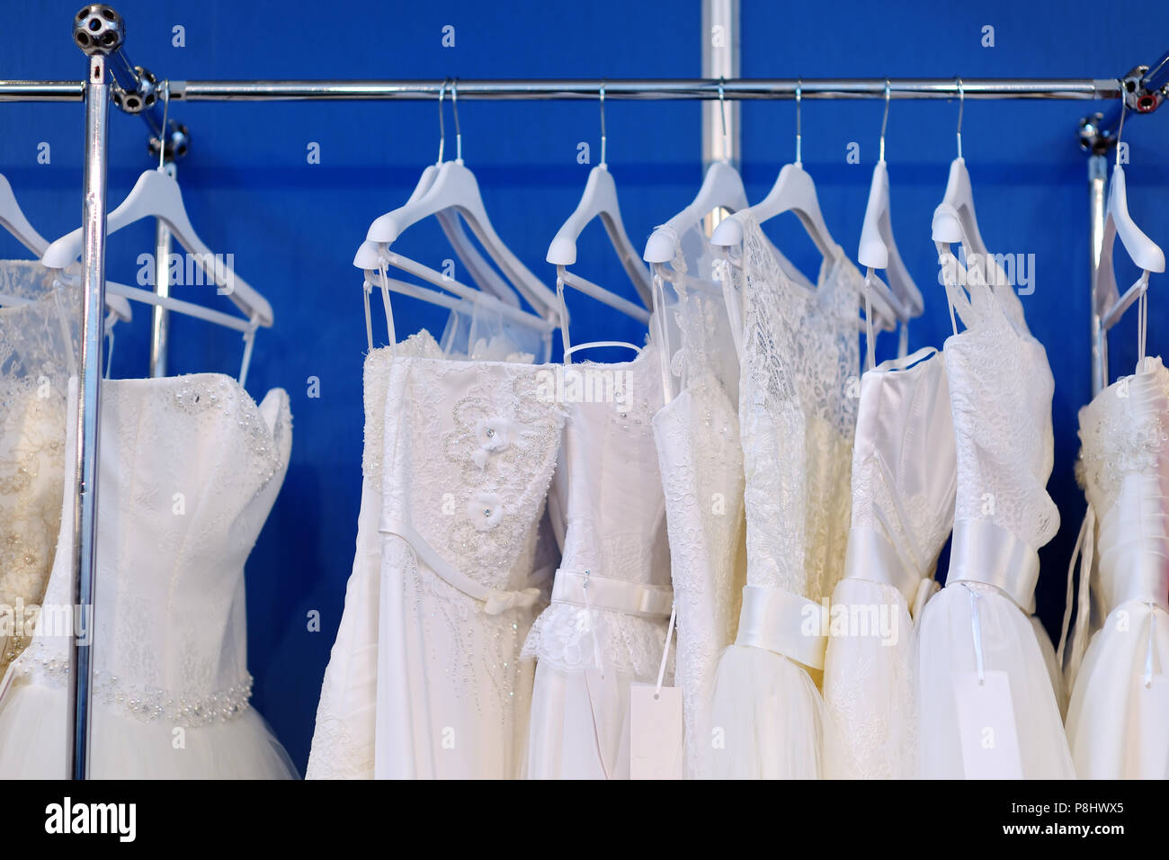 A few beautiful wedding dresses on a hanger Stock Photo - Alamy