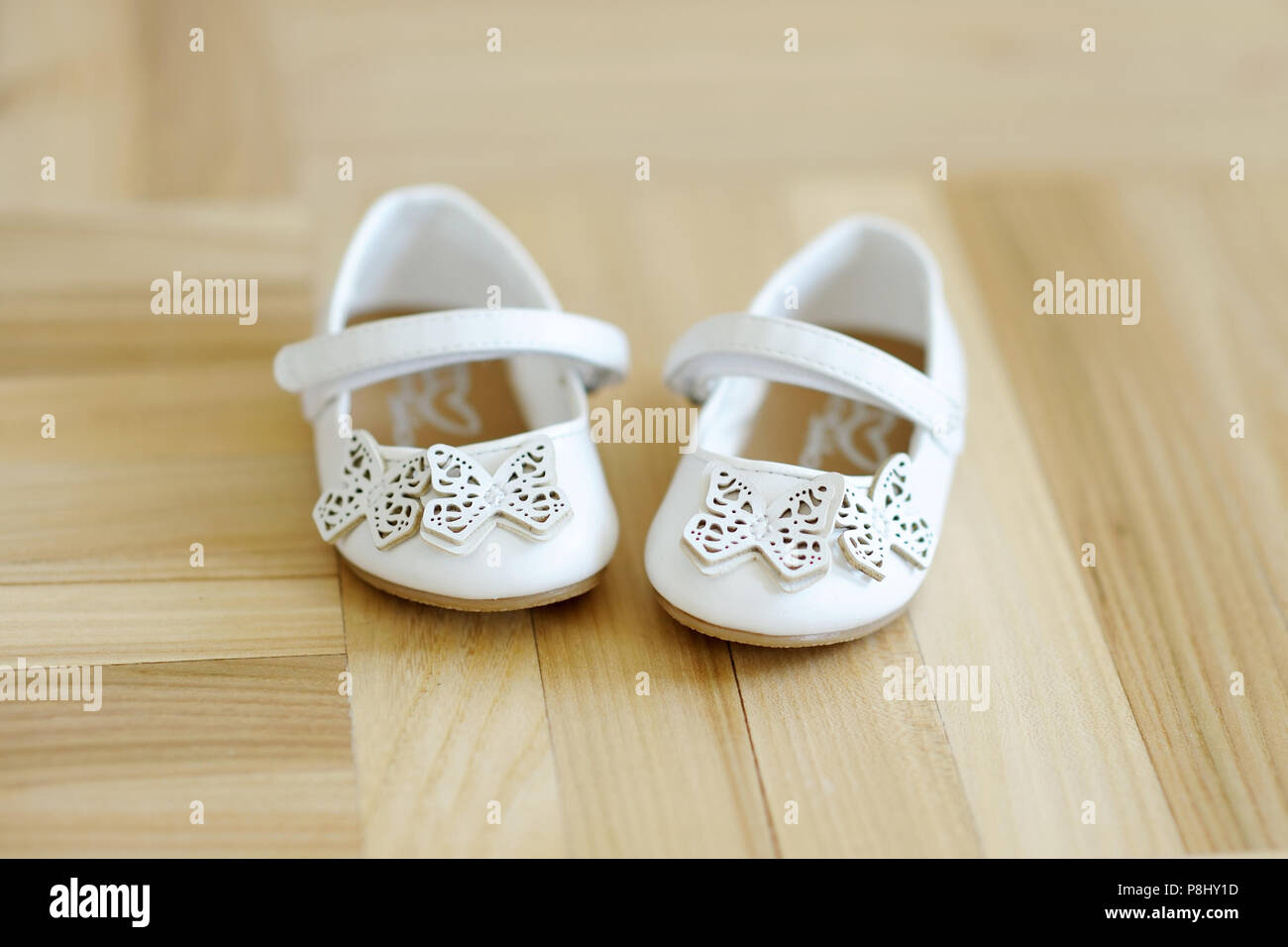 Cute little baby shoes on a wooden 