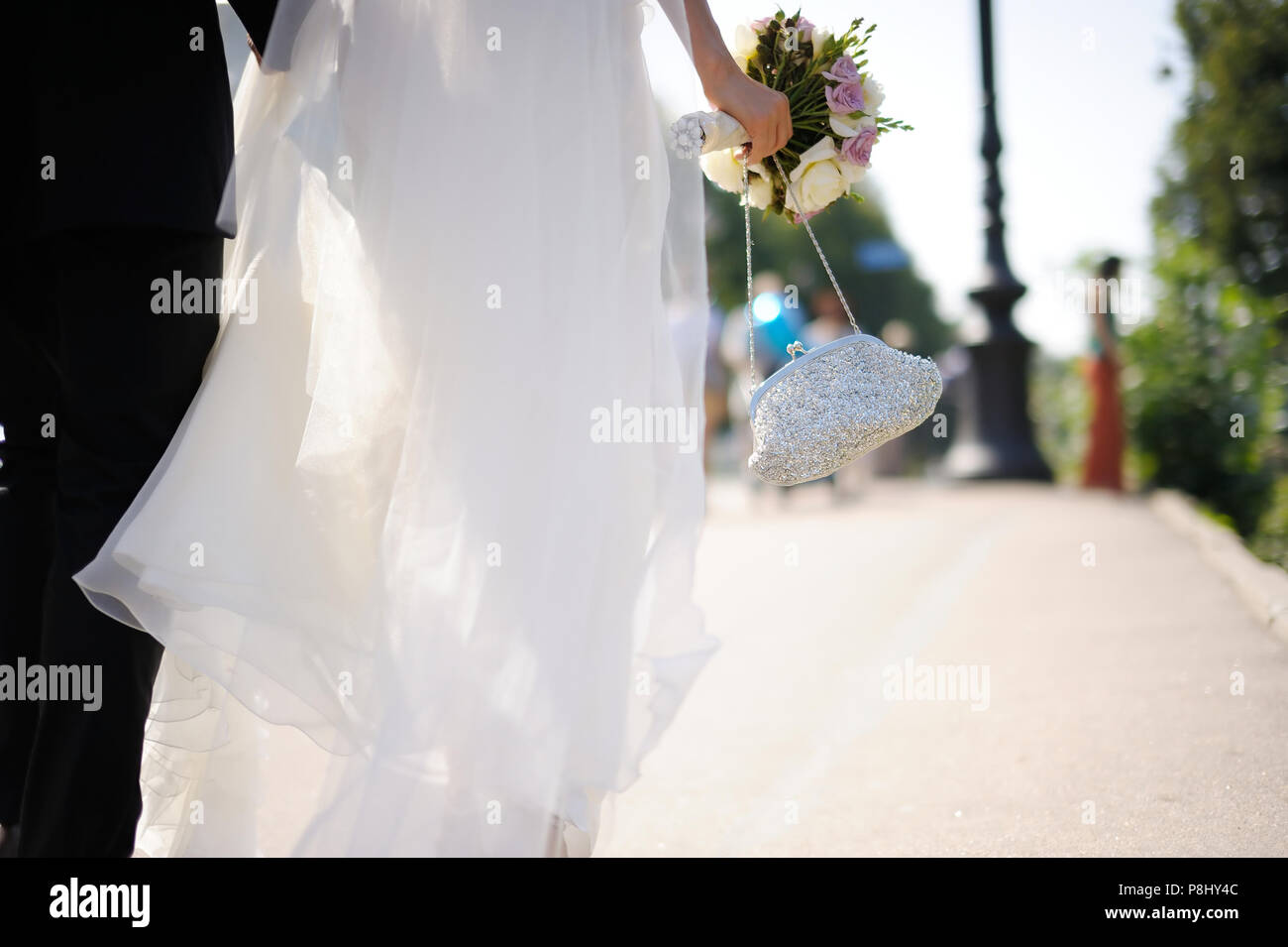 Bride and groom walking across the street Stock Photo - Alamy