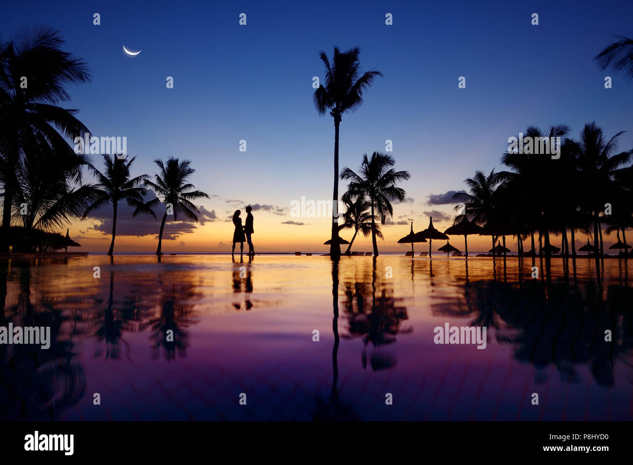 Silhouettes of young couple at scenic sunset on tropical beach Stock ...