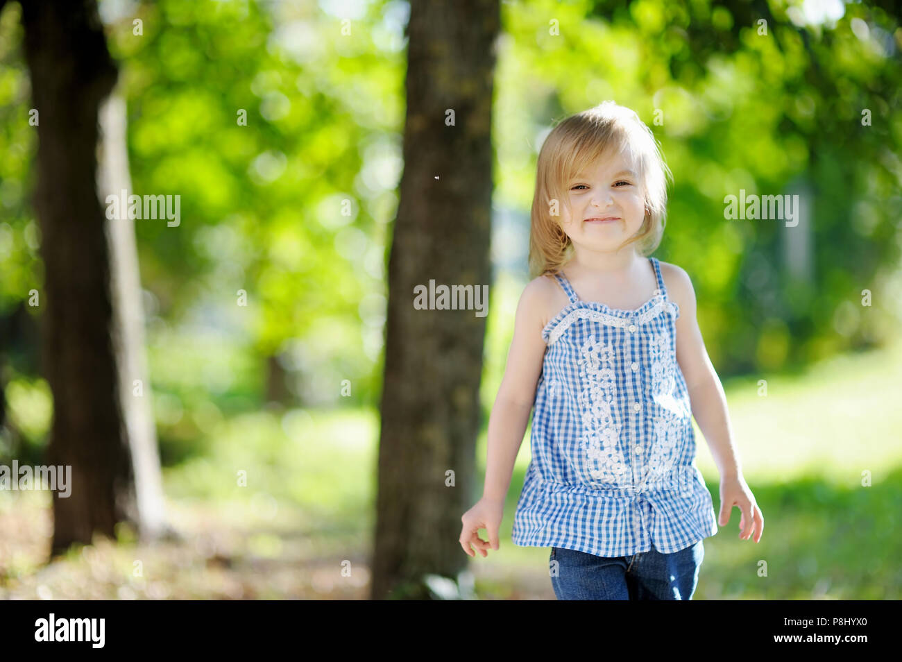Adorable little girl smiling outdoors Stock Photo - Alamy