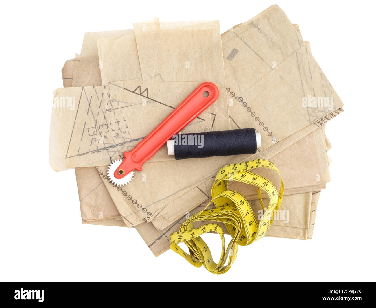 Dressmaking, sewing equipment isolated on white. Paper pattern thread, marker etc. Stock Photo