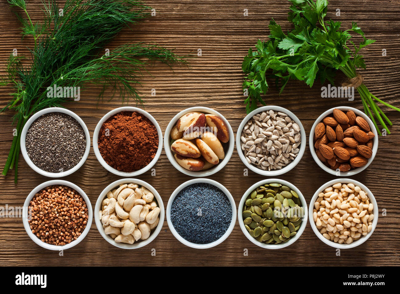 Foods rich in magnesium as pumpkin seeds, blue poppy seed, cashew nuts, almonds, sunflower seeds, buckwheat, cocoa, chia, pine nuts, brazil nuts, pars Stock Photo