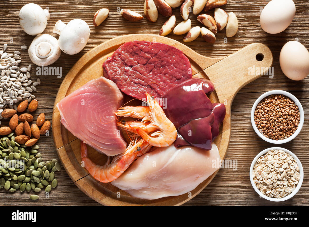 Foods High in Selenium as brasil nuts, tuna, shrimps, beef, liver, mushrooms, pumpkin seeds, sunflower seeds, buckwheat, oatmeal, almonds and eggs. To Stock Photo