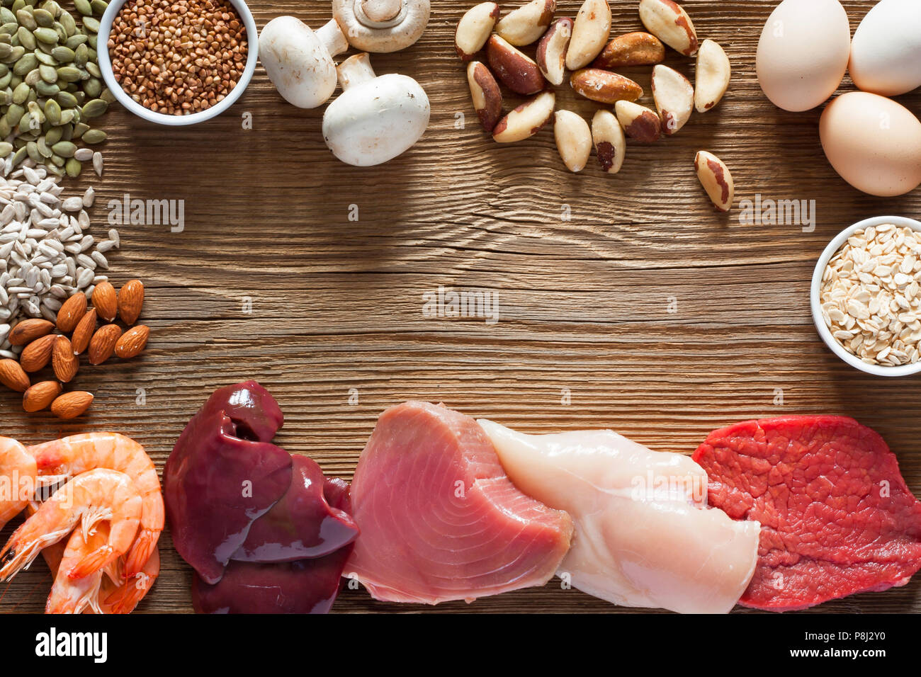 Foods High in Selenium as brasil nuts, tuna, shrimps, beef, liver, mushrooms, pumpkin seeds, sunflower seeds, buckwheat, oatmeal, almonds and eggs. To Stock Photo