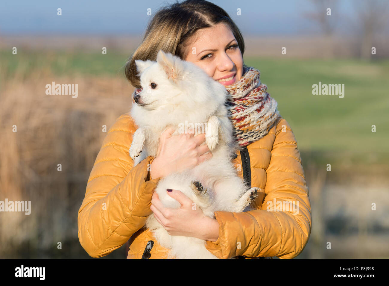 Happy girl with her little dog in nature Stock Photo - Alamy