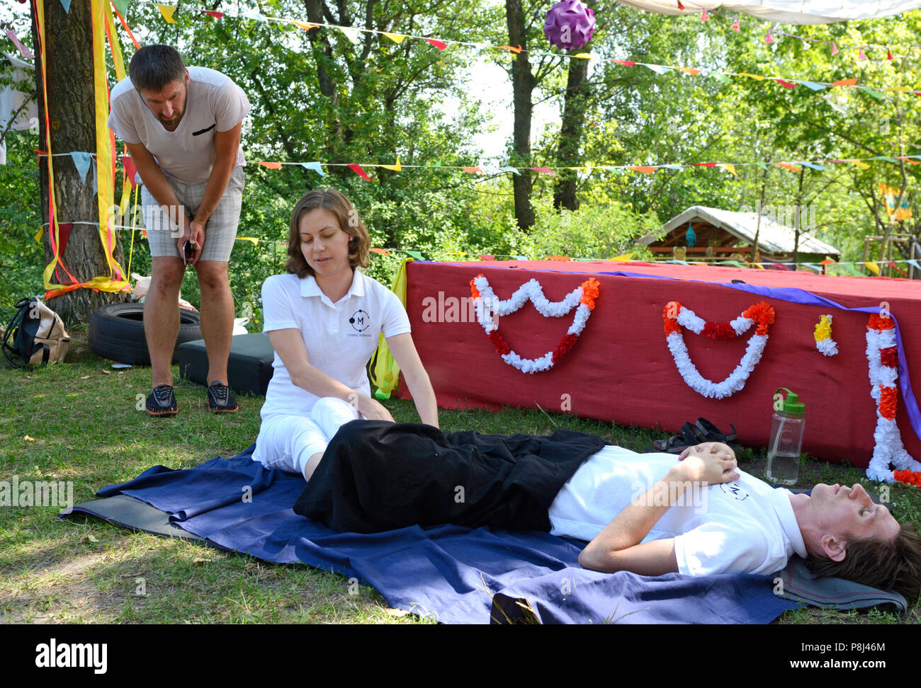 People practicing Thai massage during festival of Yoga and Vedic Culture  “Vedalife-2017, Island”. August 7, 2017. Kiev, Ukraine Stock Photo - Alamy